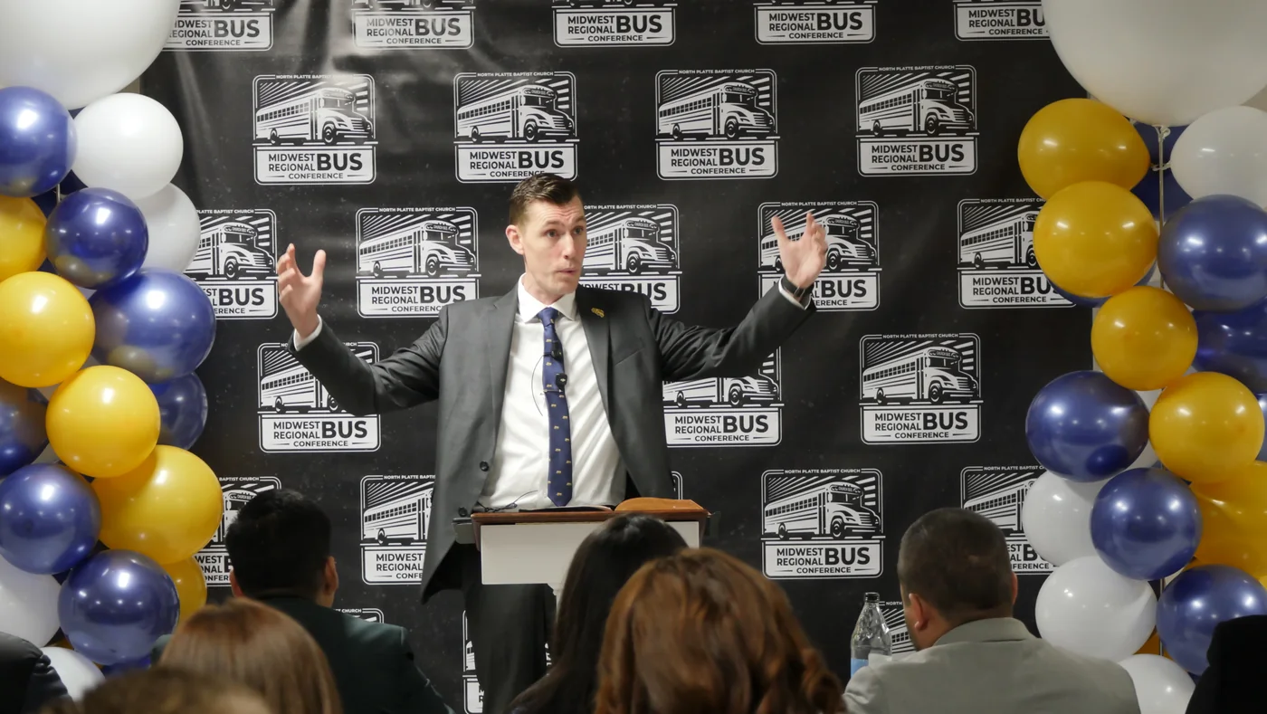 A speaker teaching a morning session in front of the MRBC backdrop