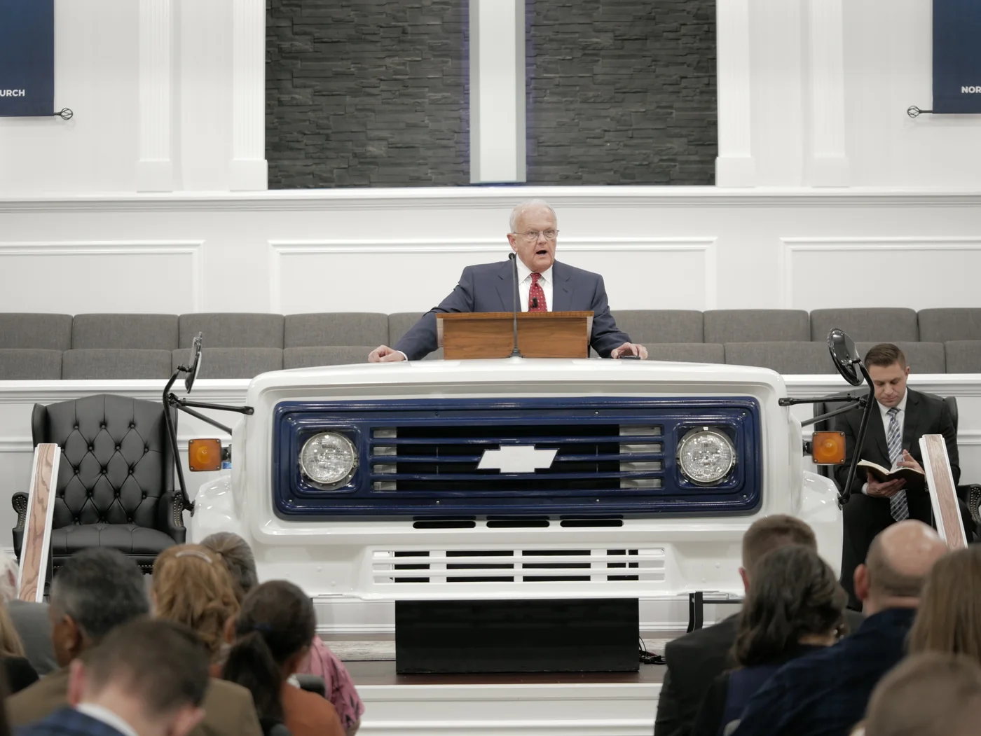 A guest preacher at the pulpit built from the front of a white bus on Monday night