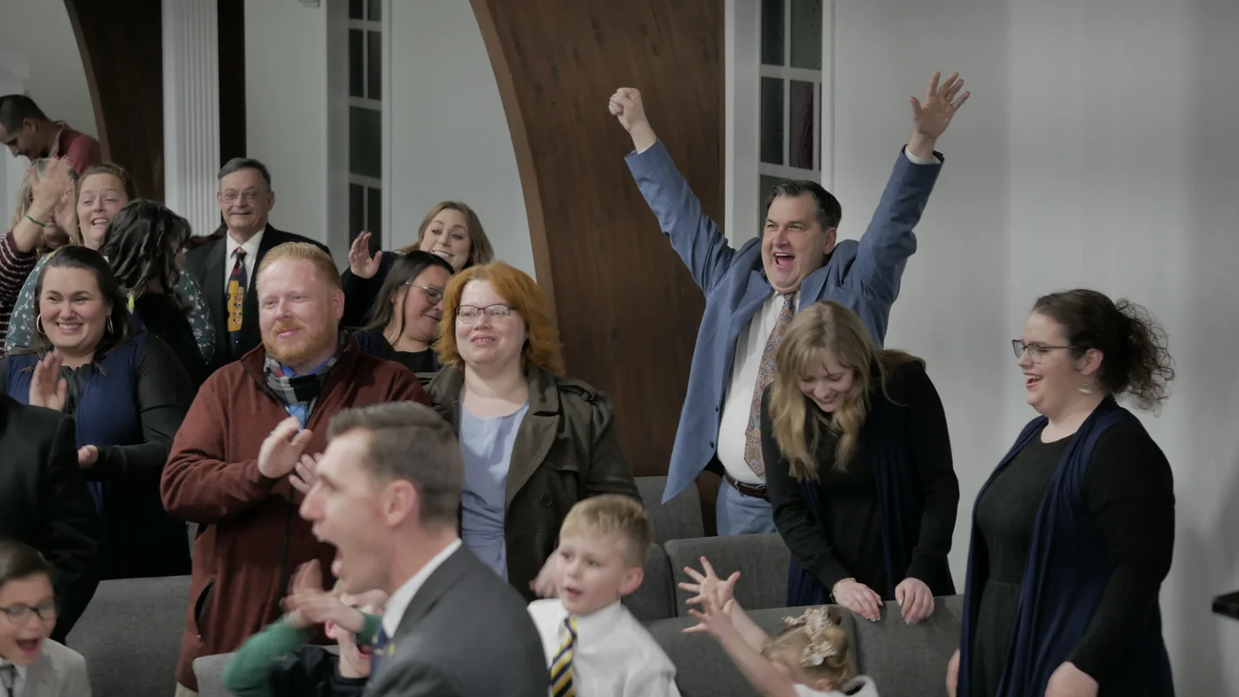 People cheering with their arms raised on Tuesday night